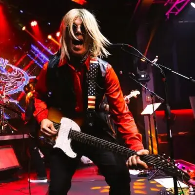 Member of the American Petty band playing the guitar.