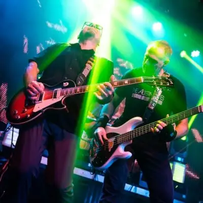 two members of the The Alternatives band playing guitars