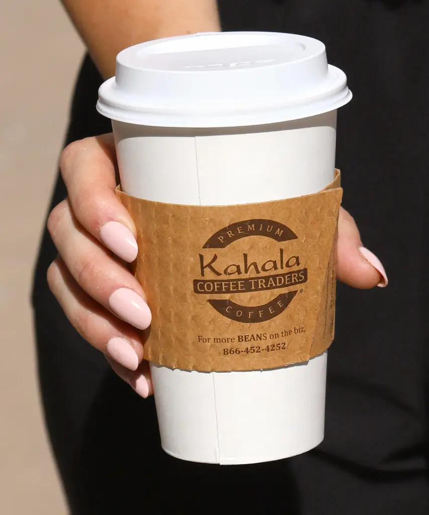 Hand holding Kahala Coffee Traders cup