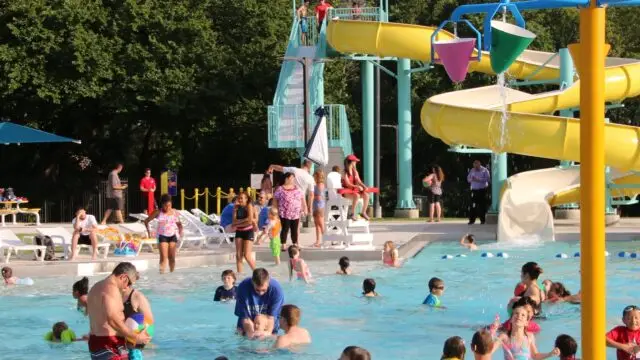 Kids swimming and splashing at public pool