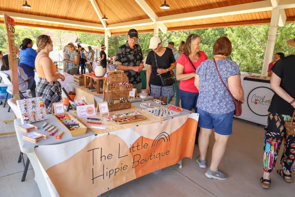 People under a pavilion at an artist market