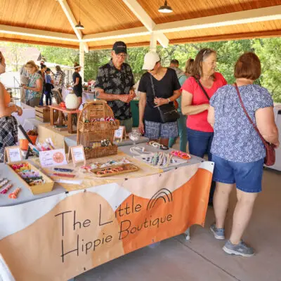 People under a pavilion at an artist market