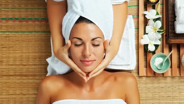 Woman getting a facial treatment in a spa environment