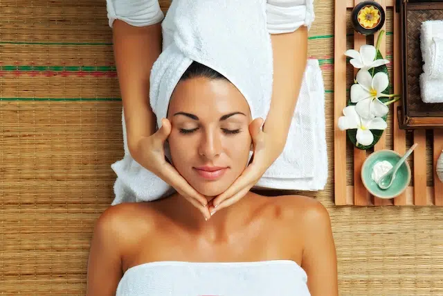 Woman getting a facial treatment in a spa environment