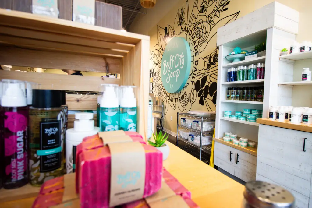 Handmade soaps and bath products displayed inside Buff City Soap in Allen, Texas.