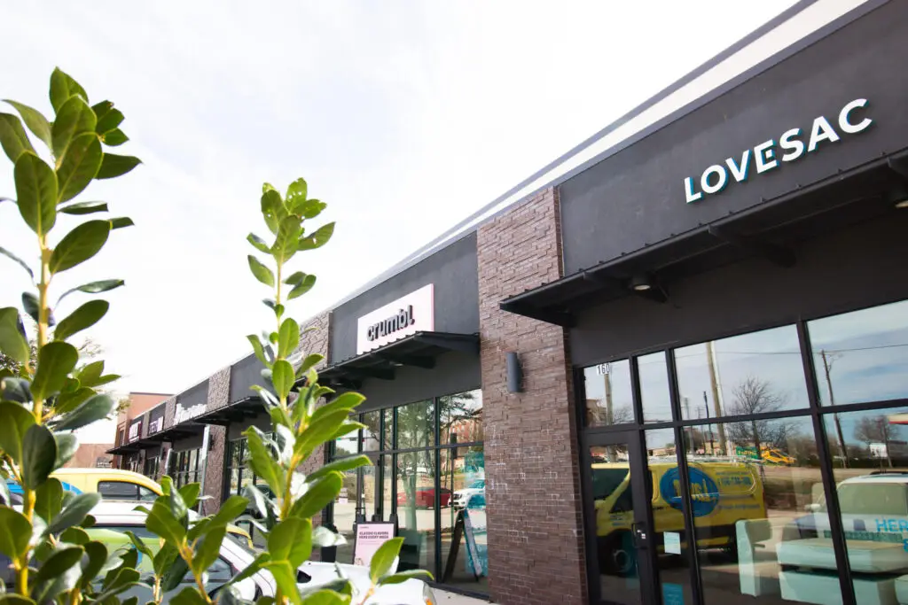Storefronts including Lovesac and other retailers at Stacy Green shopping district in Allen, Texas.