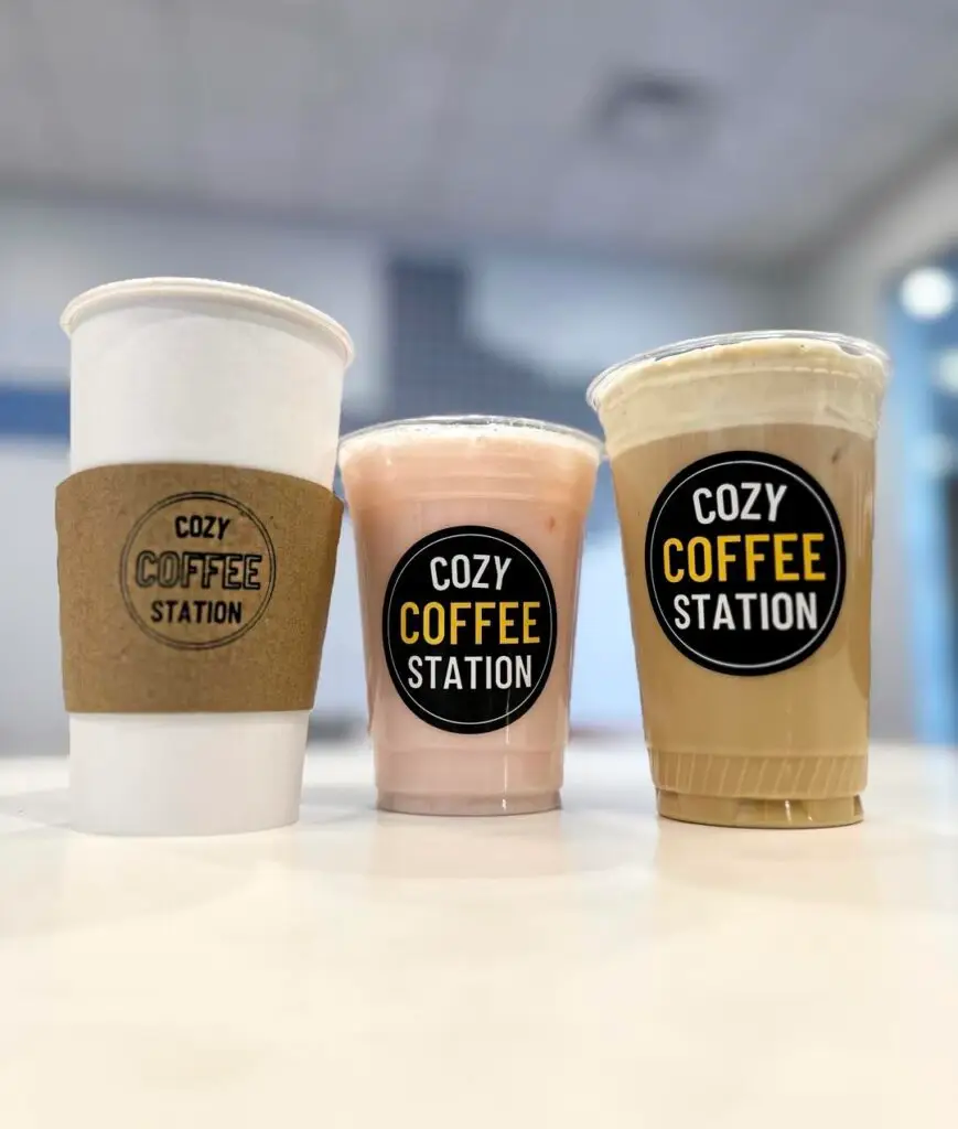 Three coffee drinks in branded cups from Cozy Coffee Station in Allen, Texas, including a hot coffee, iced latte, and blended drink.