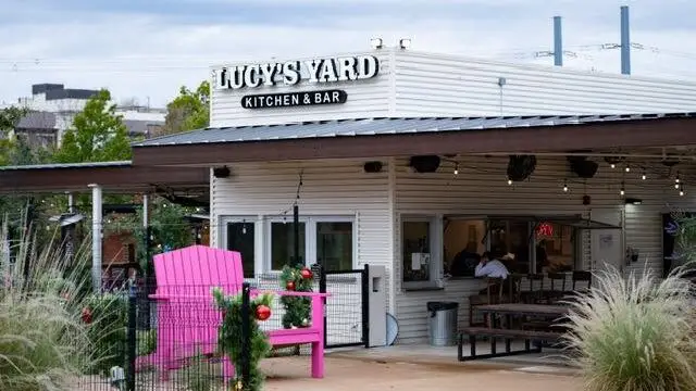 Exterior of Lucy’s Yard Kitchen and Bar with outdoor seating and patio area in Allen, Texas.