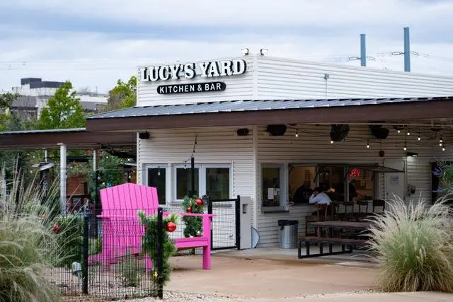 Exterior of Lucy’s Yard Kitchen and Bar with outdoor seating and patio area in Allen, Texas.