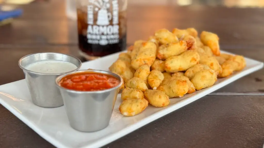 Plate of fried cheese curds with dipping sauces at Armor Brewing Co. in Allen, Texas.