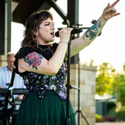 The lead singer of The 8Tracks performs on stage.