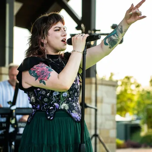 The lead singer of The 8Tracks performs on stage.