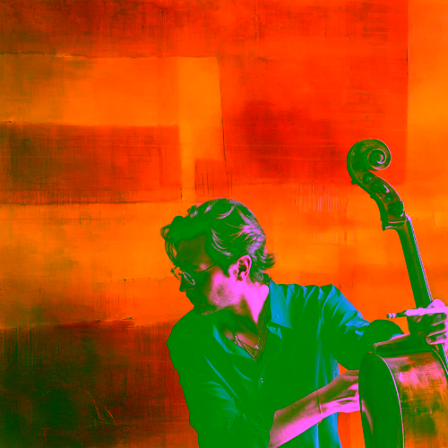 Cellist Joseph Kuipers holding his cello against a vibrant orange and yellow abstract background.
